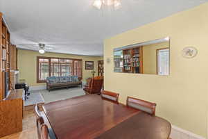 Dining space featuring light parquet flooring and ceiling fan