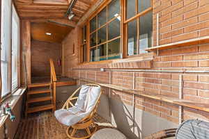 Sunroom featuring wooden ceiling