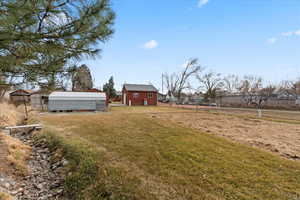 View of yard with an outbuilding