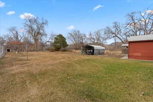 View of yard with a carport