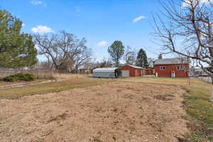 View of yard with a garage and an outdoor structure