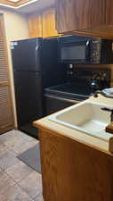 Kitchen with sink and black appliances