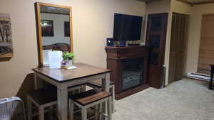 Dining room featuring baseboard heating and light carpet