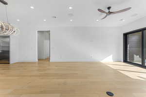 Empty room featuring ceiling fan and light hardwood / wood-style flooring