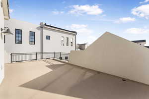 View of patio featuring a balcony