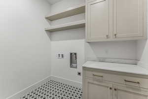 Laundry area with electric dryer hookup, washer hookup, and cabinets