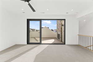 Carpeted spare room with ceiling fan