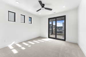 Spare room with light colored carpet and ceiling fan