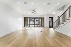 Unfurnished living room featuring ceiling fan, a textured ceiling, and light wood-type flooring