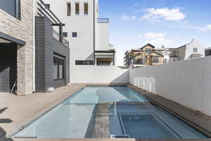 View of pool featuring an in ground hot tub and a patio