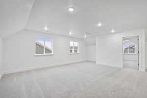 Basement with light carpet and a textured ceiling