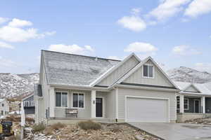 View of front facade with a garage and a mountain view