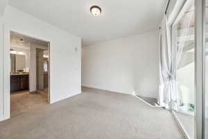 Empty room featuring light colored carpet