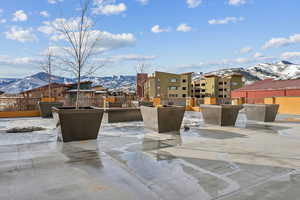 Snow covered patio featuring a mountain view