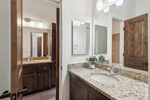 Bathroom featuring tile patterned flooring and vanity