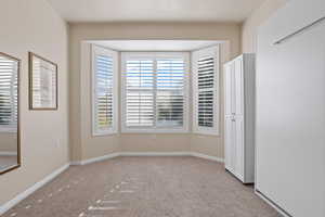 Empty room featuring light carpet