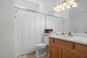 Bathroom featuring tile patterned floors, toilet, and vanity