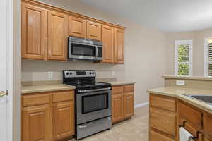 Kitchen with stainless steel appliances and light tile patterned flooring