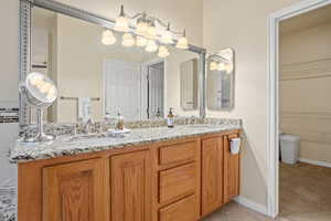 Bathroom with tile patterned flooring and vanity