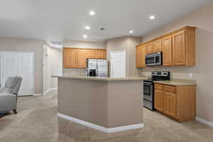 Kitchen with appliances with stainless steel finishes and a kitchen island