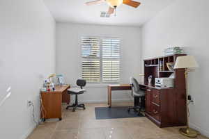 Office area with light tile patterned floors and ceiling fan