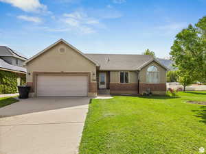 Ranch-style home with a garage and a front yard