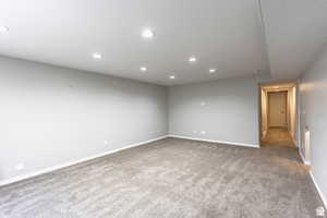 Empty room with carpet and a textured ceiling