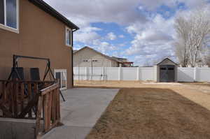 View of yard with a shed and a patio area