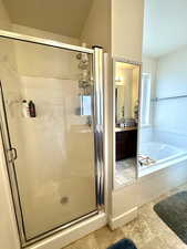 Bathroom featuring vanity, separate shower and tub, tile patterned flooring, and a textured ceiling