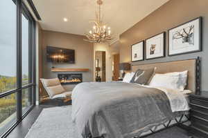 Bedroom with an inviting chandelier and floor to ceiling windows