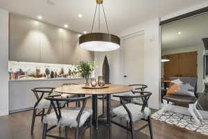 Dining area featuring dark wood-type flooring