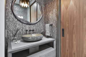 Bathroom with vanity and a chandelier