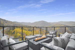 Balcony featuring a mountain view and a fire pit