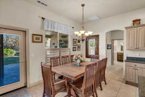 Tiled dining space with an inviting chandelier