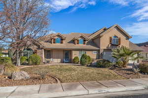 View of front of home with a garage and a front yard