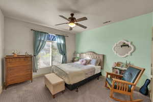 Carpeted bedroom with ceiling fan