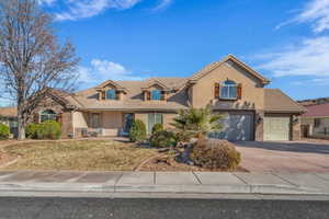 View of front of house with a garage and a front yard