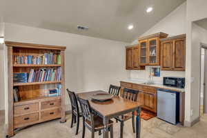 Kitchen featuring dishwasher, lofted ceiling, and sink