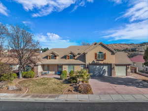 View of front of home featuring a garage and a front lawn