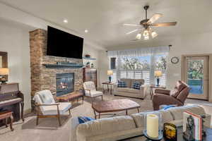 Living room featuring ceiling fan and a fireplace