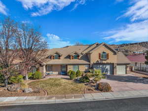 View of front of house featuring a garage and a front lawn