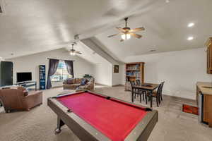 Rec room with vaulted ceiling, light carpet, pool table, and ceiling fan