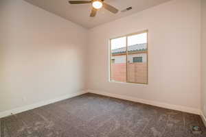 Unfurnished room featuring carpet floors and ceiling fan