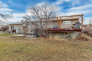 Rear view of property with a yard