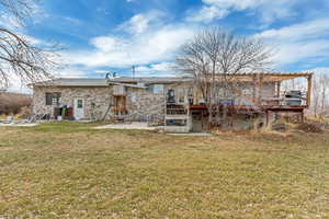 Rear view of property with a yard, a pergola, and a patio