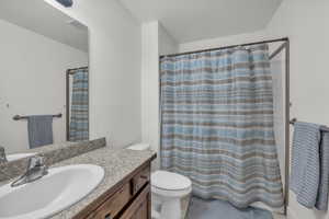 Bathroom featuring vanity, tile patterned floors, and toilet