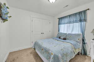 Bedroom with carpet floors and a closet