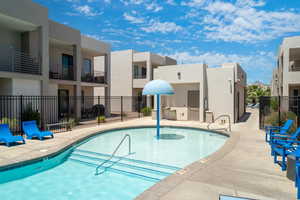 View of swimming pool with an outdoor kitchen and a patio area