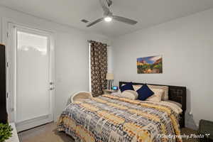 Carpeted bedroom with ceiling fan