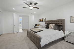 Bedroom with ceiling fan and light colored carpet